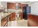 Modern kitchen with stainless steel appliances and dark wood cabinets at 1880 E Morten Ave # 206, Phoenix, AZ 85020