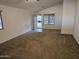 Spacious living room with neutral carpeting and ceiling fan at 19002 N Toledo Ave, Maricopa, AZ 85138