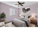 Bright bedroom with carpeted floor, ceiling fan, and window blinds at 19137 W Jackson St, Buckeye, AZ 85326