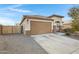 House exterior featuring a two-car garage and desert landscaping at 19137 W Jackson St, Buckeye, AZ 85326