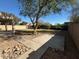 Backyard with grassy area, patio, and gravel landscaping at 20457 N 80Th Dr, Peoria, AZ 85382