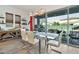 Bright dining room with glass table and chairs, leading to a patio at 21002 E Mayberry Rd, Queen Creek, AZ 85142