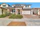 Two-story home with stone accents and a two-car garage at 21002 E Mayberry Rd, Queen Creek, AZ 85142