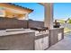 Outdoor kitchen features a built-in grill, prep station, and cabinets at 21002 E Mayberry Rd, Queen Creek, AZ 85142