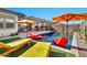 Refreshing pool with patio furniture and colorful accents at 21002 E Mayberry Rd, Queen Creek, AZ 85142