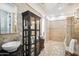 Elegant bathroom with double sinks, a glass shower, and a large tile floor at 2207 W Hidden Treasure Way, Phoenix, AZ 85086