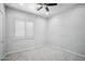 Simple bedroom with ceiling fan and window shutters at 2207 W Hidden Treasure Way, Phoenix, AZ 85086