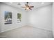 Bright bedroom with ceiling fan and window shutters at 2207 W Hidden Treasure Way, Phoenix, AZ 85086