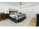 Cozy bedroom with a queen bed, wood dresser, and ceiling fan at 2246 E Bethany Home Rd, Phoenix, AZ 85016