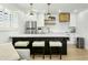 Modern kitchen with white cabinets and a breakfast bar at 2246 E Bethany Home Rd, Phoenix, AZ 85016