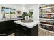 Bright kitchen featuring a large pantry and marble-topped island at 2246 E Bethany Home Rd, Phoenix, AZ 85016