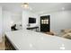 Open concept kitchen with white marble island, and a view into living area at 2246 E Bethany Home Rd, Phoenix, AZ 85016