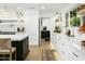 Modern kitchen with white cabinets, marble countertops and breakfast bar at 2246 E Bethany Home Rd, Phoenix, AZ 85016