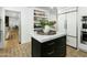 Modern kitchen with marble island, herringbone floors, and stainless steel appliances at 2246 E Bethany Home Rd, Phoenix, AZ 85016