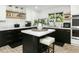 Stylish kitchen with black and white cabinetry and a herringbone tile floor at 2246 E Bethany Home Rd, Phoenix, AZ 85016