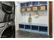 Well-organized laundry room with blue cubbies and storage at 2246 E Bethany Home Rd, Phoenix, AZ 85016