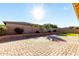 Spacious backyard with grassy area and brick pavers at 22643 E Stonecrest Dr, Queen Creek, AZ 85142