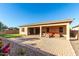 Covered patio with seating area and grassy backyard at 22643 E Stonecrest Dr, Queen Creek, AZ 85142