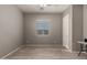 Well-lit bedroom with window, closet, and view into hallway at 22643 E Stonecrest Dr, Queen Creek, AZ 85142