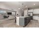 Kitchen island with granite countertop, seating, and modern lighting at 22643 E Stonecrest Dr, Queen Creek, AZ 85142