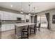 Kitchen island with granite countertop and bar stools, offering additional seating at 22643 E Stonecrest Dr, Queen Creek, AZ 85142