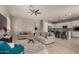 Open concept living room and kitchen with gray floors and white cabinets at 22643 E Stonecrest Dr, Queen Creek, AZ 85142