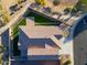 Aerial view of a house with a tile roof, artificial turf, and paved driveway at 2408 N Morrison Ave, Casa Grande, AZ 85122