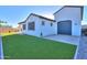 Artificial turf lawn and view of home's exterior and garage at 2408 N Morrison Ave, Casa Grande, AZ 85122