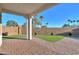 Landscaped backyard with a covered patio and artificial turf at 2408 N Morrison Ave, Casa Grande, AZ 85122