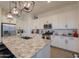 White kitchen cabinets, granite countertops, and island at 2408 N Morrison Ave, Casa Grande, AZ 85122