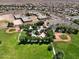 Aerial view features a school and community park with baseball fields, playgrounds, and green spaces at 25969 W Tina Ln, Buckeye, AZ 85396