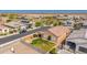 An aerial view shows a well maintained home with desert landscaping and solar panels in a residential neighborhood at 25969 W Tina Ln, Buckeye, AZ 85396