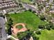 This aerial image captures the baseball field and community park with its sprawling green space at 25969 W Tina Ln, Buckeye, AZ 85396