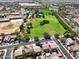 An aerial view showcasing the community's park, school, and well-maintained residential area at 25969 W Tina Ln, Buckeye, AZ 85396