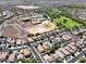 An elevated view highlights the neighborhood, school, and community amenities, including a baseball field at 25969 W Tina Ln, Buckeye, AZ 85396