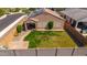 Aerial view of a private backyard with green grass, patio, desert landscaping, and solar panels at 25969 W Tina Ln, Buckeye, AZ 85396