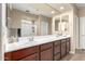 Double vanity bathroom with large mirror and walk-in shower at 25969 W Tina Ln, Buckeye, AZ 85396