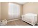 Bedroom with crib, closet and neutral decor at 25969 W Tina Ln, Buckeye, AZ 85396