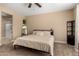 Spacious bedroom with ceiling fan, full-size bed, and en-suite bathroom at 25969 W Tina Ln, Buckeye, AZ 85396