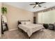 Comfortable bedroom with ceiling fan, full-size bed, and plenty of storage at 25969 W Tina Ln, Buckeye, AZ 85396