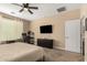 Well-lit bedroom with ceiling fan, dresser, and full-size bed at 25969 W Tina Ln, Buckeye, AZ 85396