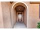 Covered entryway with arched entry and a dark brown front door at 25969 W Tina Ln, Buckeye, AZ 85396