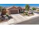 Charming single-story home featuring a two-car garage, desert landscaping, and a tile roof at 25969 W Tina Ln, Buckeye, AZ 85396