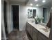 Double vanity bathroom with large mirrors and modern fixtures at 26035 W Quail Ave, Buckeye, AZ 85396