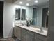 Double vanity bathroom with large mirrors and modern fixtures at 26035 W Quail Ave, Buckeye, AZ 85396