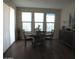 Bright dining room featuring a round table and chairs, hardwood floors, and large windows at 26035 W Quail Ave, Buckeye, AZ 85396