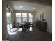 Sunlit dining area with hardwood floors, round table, and access to backyard at 26035 W Quail Ave, Buckeye, AZ 85396