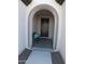 Covered entryway with arched entry and decorative bench at 26035 W Quail Ave, Buckeye, AZ 85396