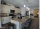 Island kitchen with granite countertops and stainless steel appliances at 26035 W Quail Ave, Buckeye, AZ 85396