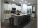 Island kitchen with granite countertops and stainless steel appliances at 26035 W Quail Ave, Buckeye, AZ 85396